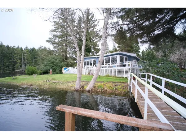 a view of an house with backyard and trees
