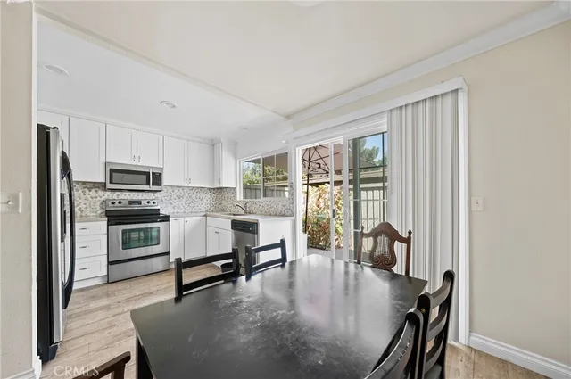 a kitchen with microwave a stove and furniture