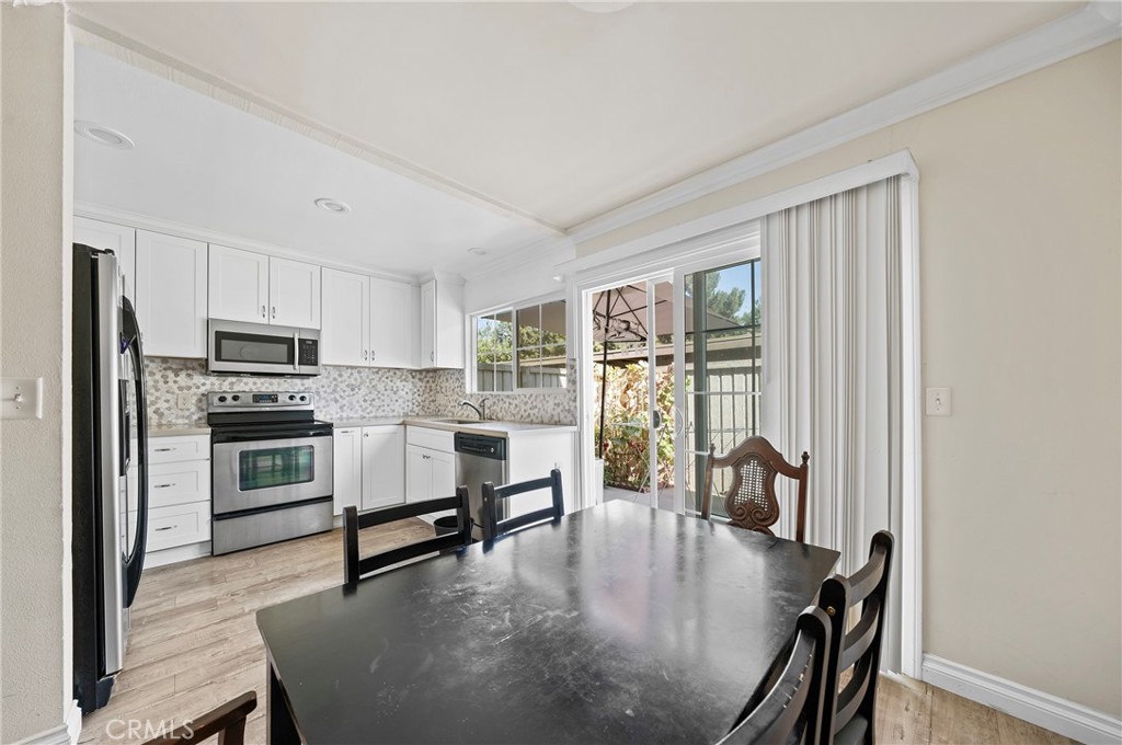 63 Streamwood Irvine, CA 92620 - Photo 11 of 25 a kitchen with microwave a stove and furniture