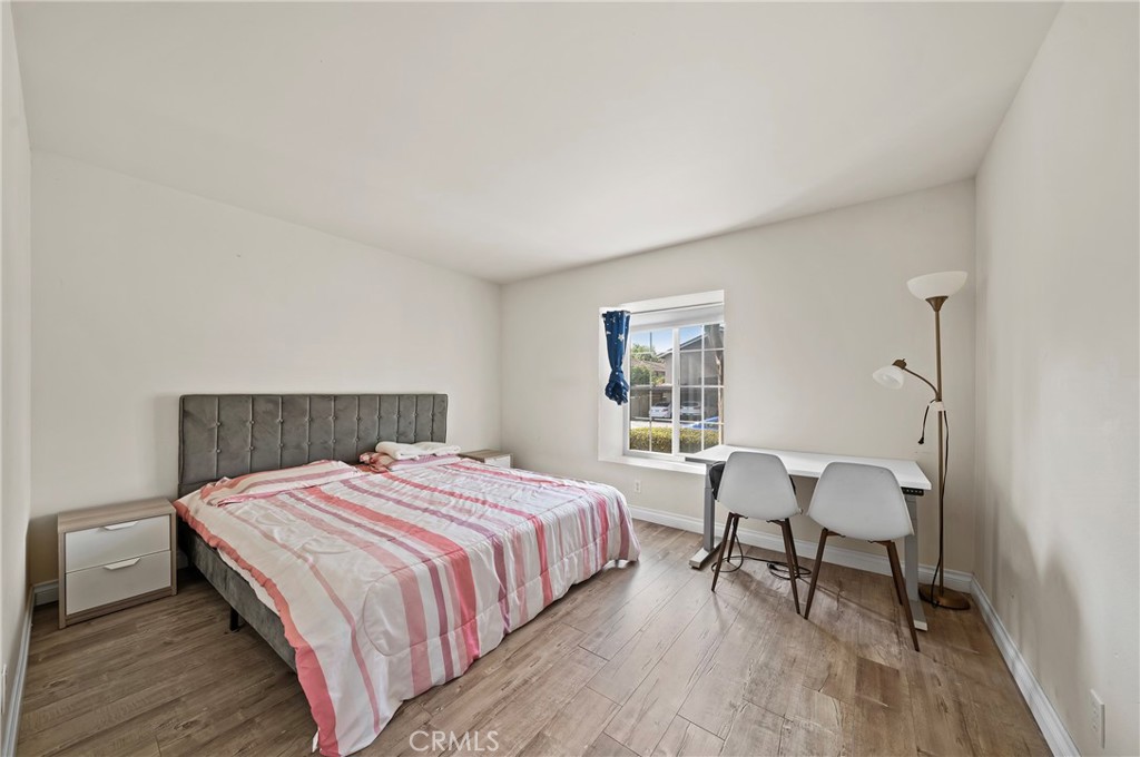 63 Streamwood Irvine, CA 92620 - Photo 14 of 25 a bedroom with a bed a table and chair