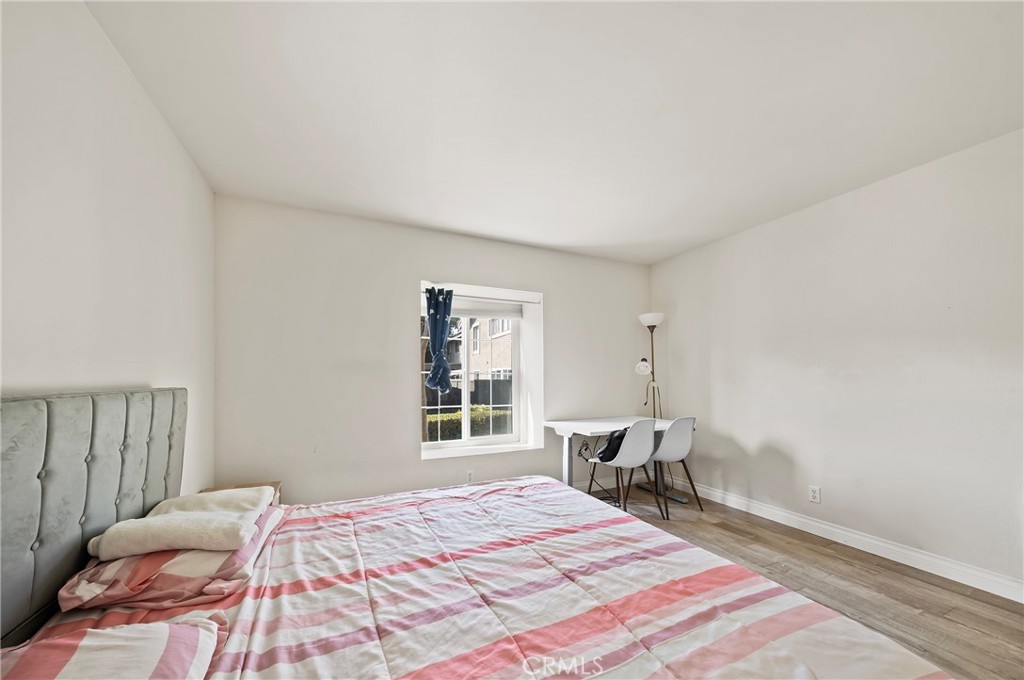 63 Streamwood Irvine, CA 92620 - Photo 16 of 25 a bed sitting in a bedroom next to a window and chair