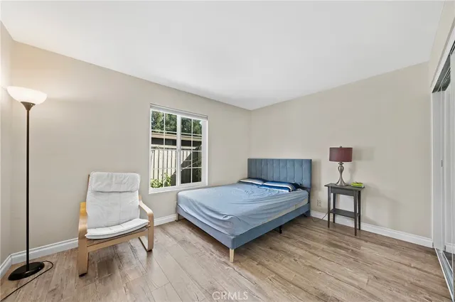 a bedroom with a bed and wooden floor