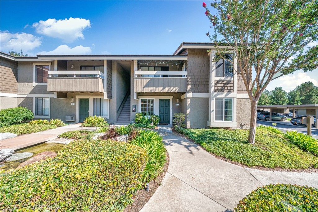 63 Streamwood Irvine, CA 92620 - Photo 2 of 25 a front view of a house with a yard