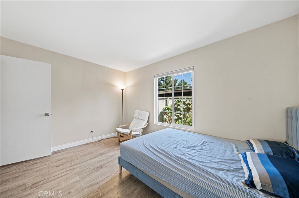63 Streamwood Irvine, CA 92620 - Photo 21 of 25 a bedroom with a bed and wooden floor