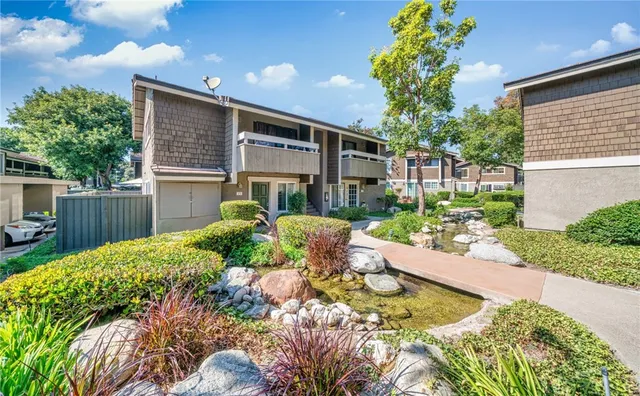 a view of a backyard with table and chairs and wooden fence
