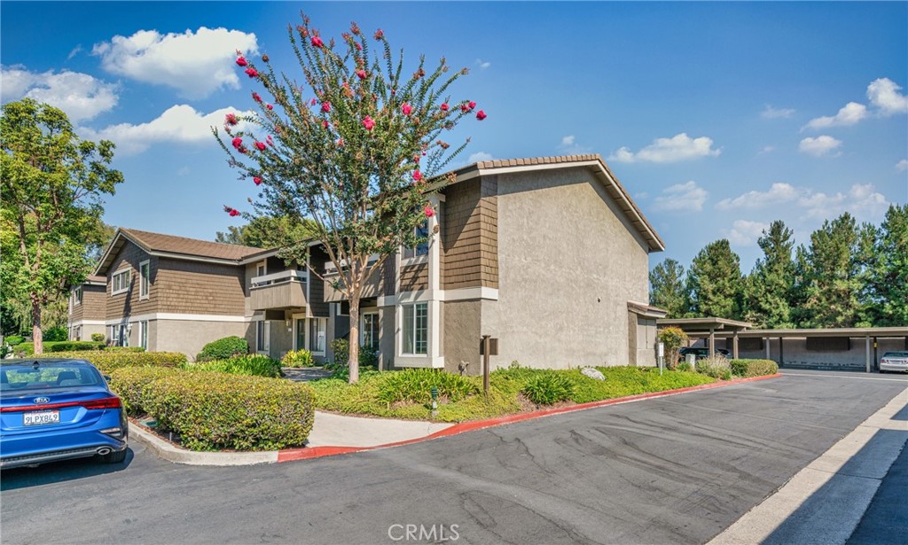 63 Streamwood Irvine, CA 92620 - Photo 5 of 25 a front view of a house with a yard and garage
