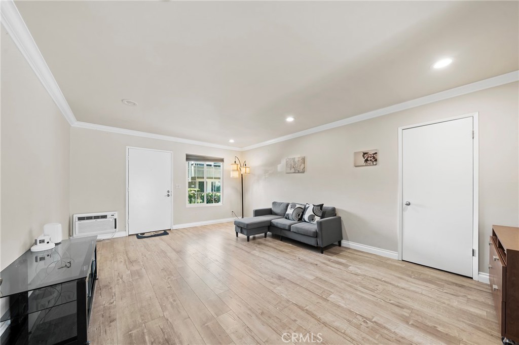 63 Streamwood Irvine, CA 92620 - Photo 8 of 25 a living room with furniture and a wooden floor