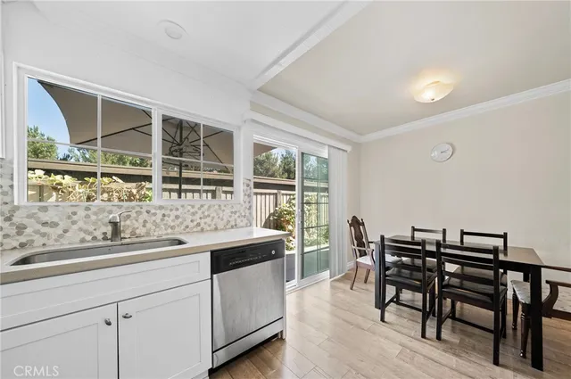 a kitchen with a sink and chairs
