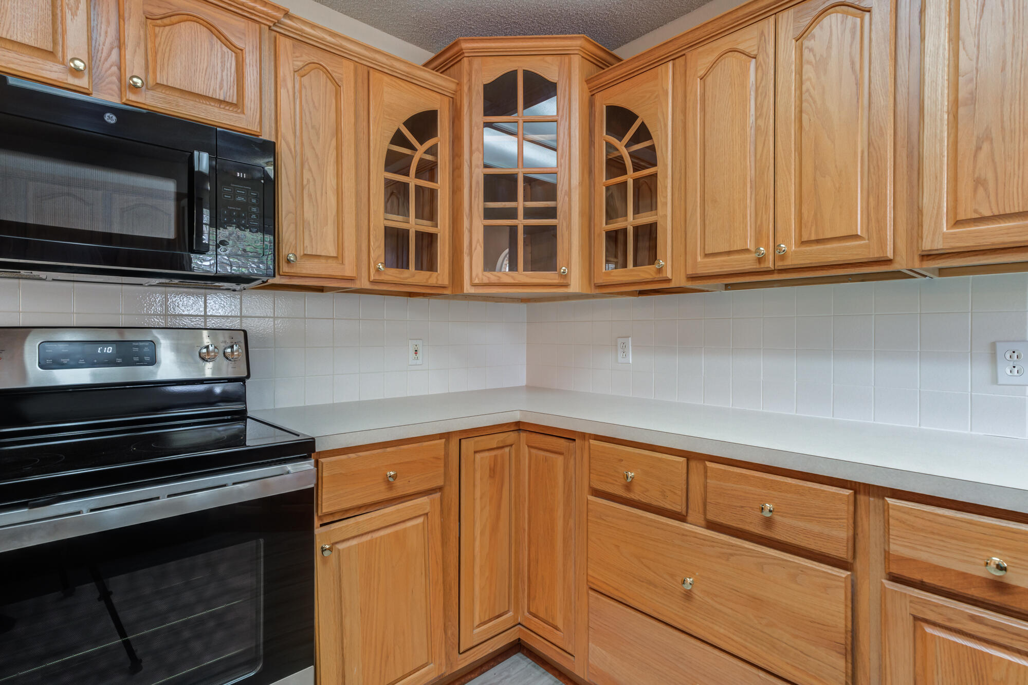 5914 88th Place Lubbock, TX 79424 - Photo 11 of 39 a kitchen with stainless steel appliances granite countertop a stove and a microwave