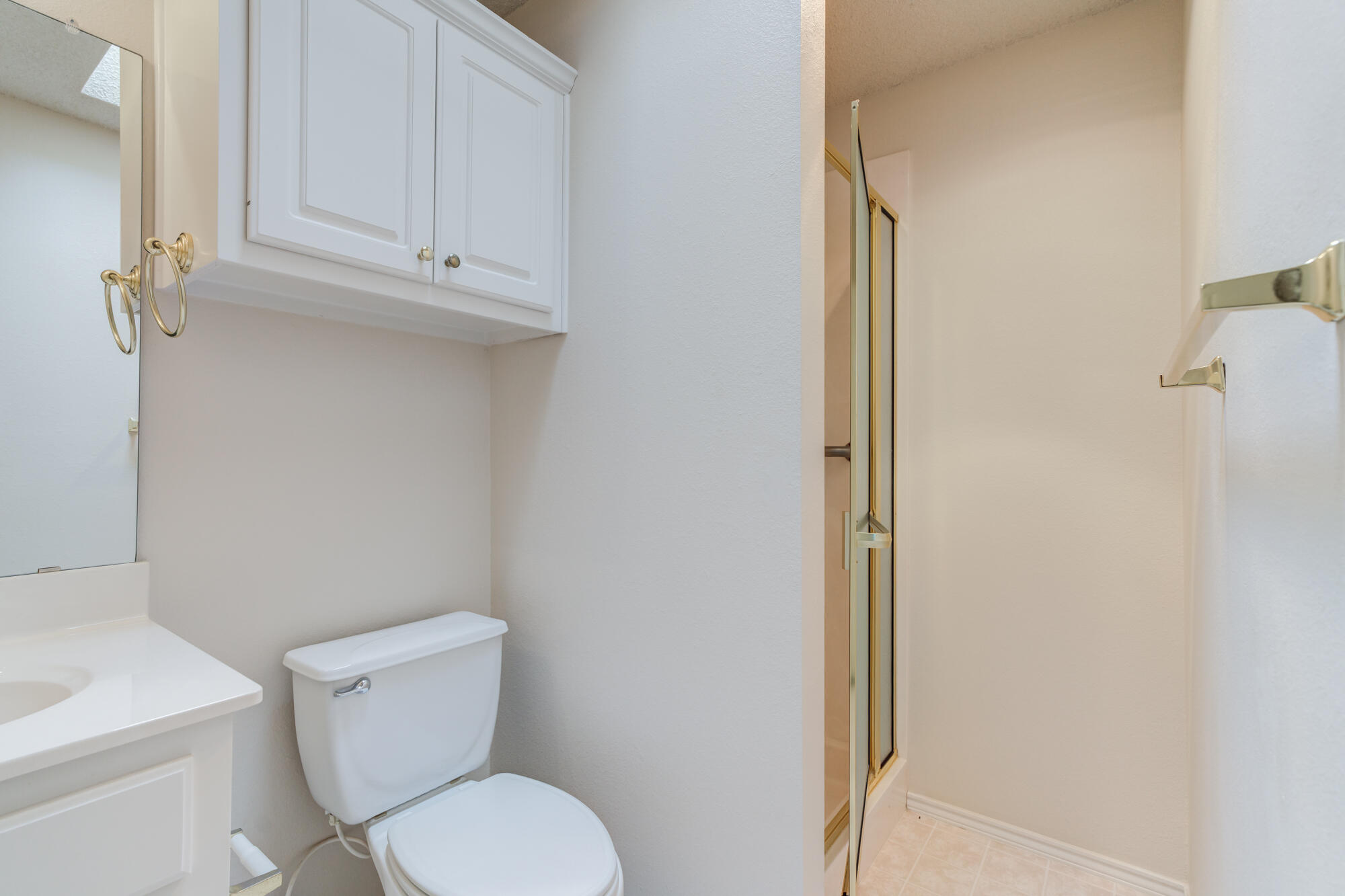 5914 88th Place Lubbock, TX 79424 - Photo 28 of 39 a white toilet sitting next to a bathroom sink