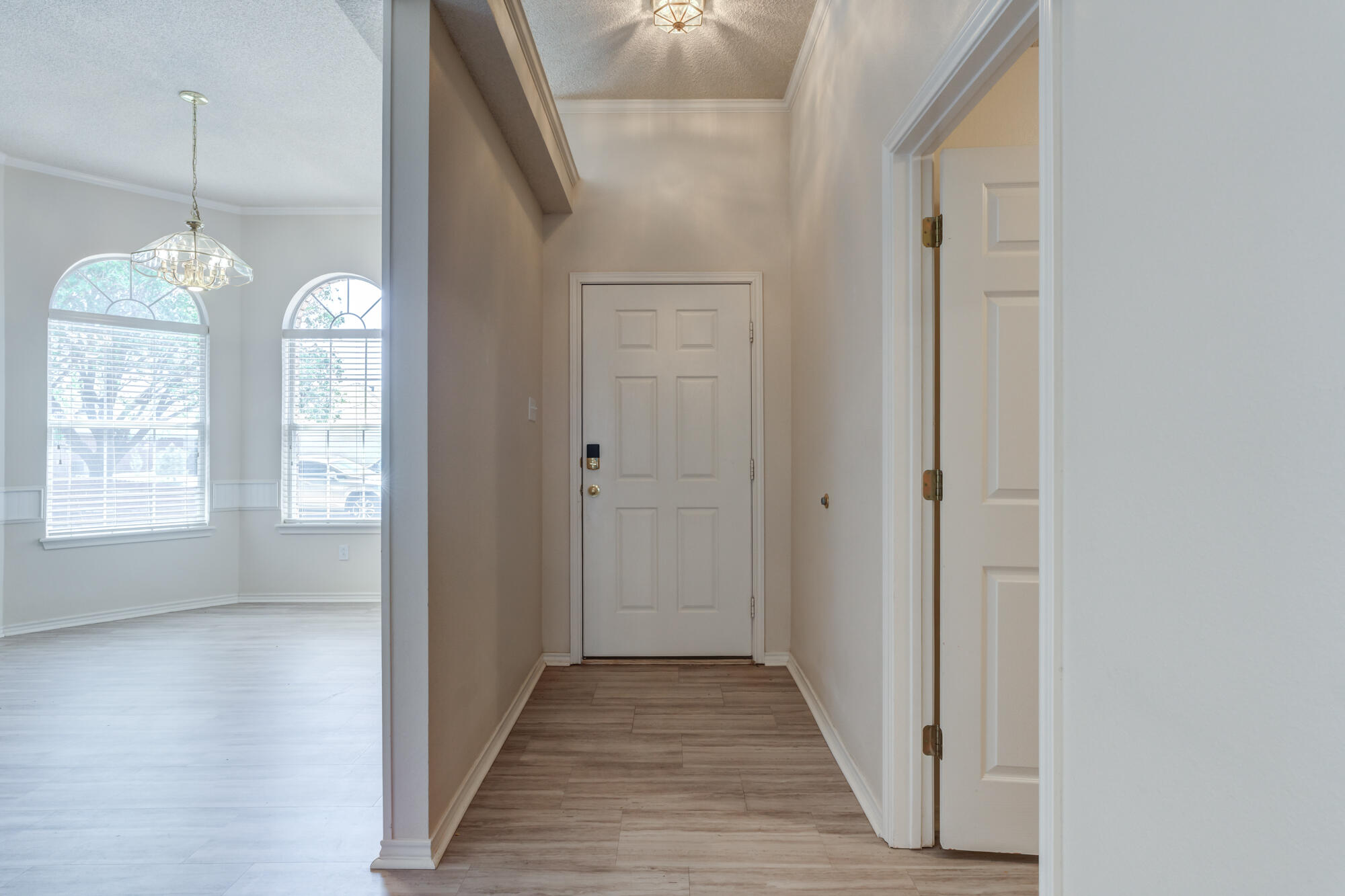 5914 88th Place Lubbock, TX 79424 - Photo 3 of 39 a view of a hallway with windows and chandelier