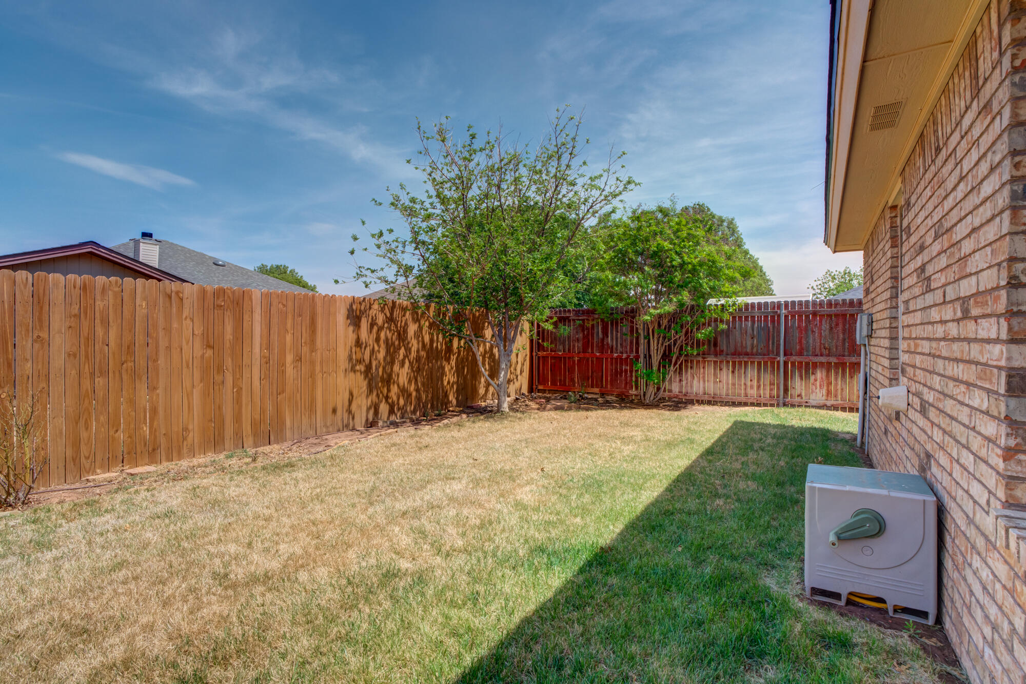 5914 88th Place Lubbock, TX 79424 - Photo 38 of 39 a front view of a house with a yard and a garage