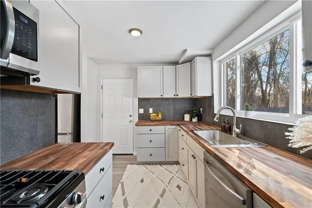 a kitchen with a sink stove and microwave