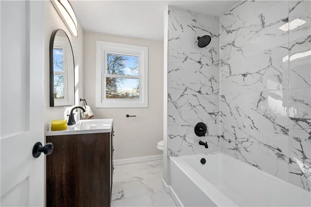 a bathroom with a bathtub a shower and a sink