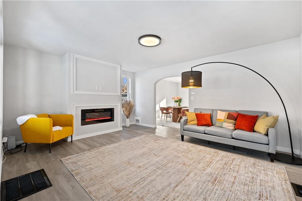 1486 Mill Street Pittsburgh, PA 15221 - Photo 7 of 25 a living room with furniture and a fireplace