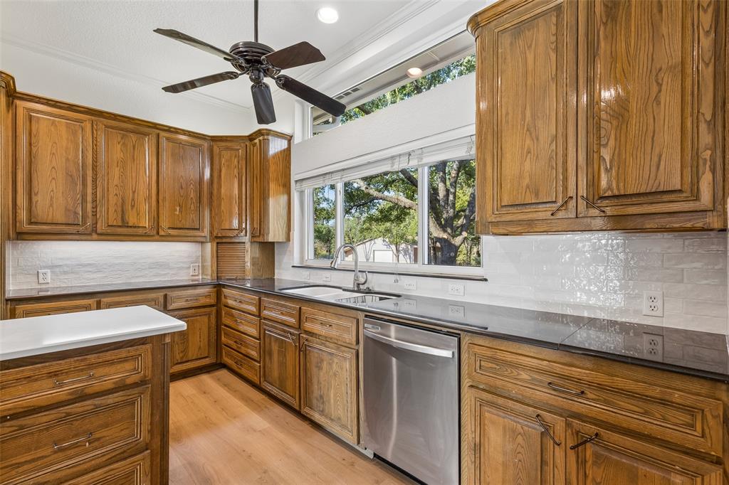 1155 Point Vista Road Hickory Creek, TX 75065 - Photo 8 of 40 Kitchen featuring wood cabinetry, stone countertops, a stainless steel dishwasher, and a ceiling fan