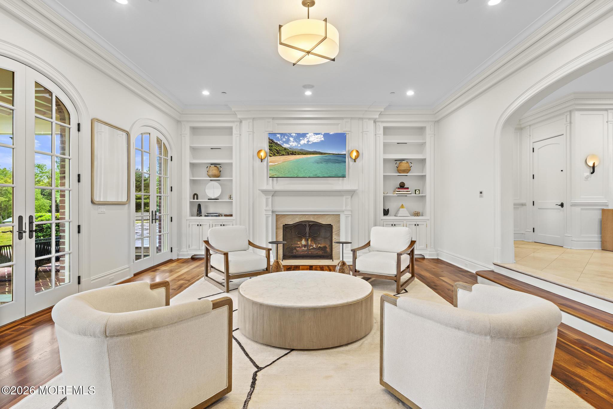 88 Montrose Road Colts Neck, NJ 07722 - Photo 8 of 73 a living room with furniture a fireplace and a flat screen tv