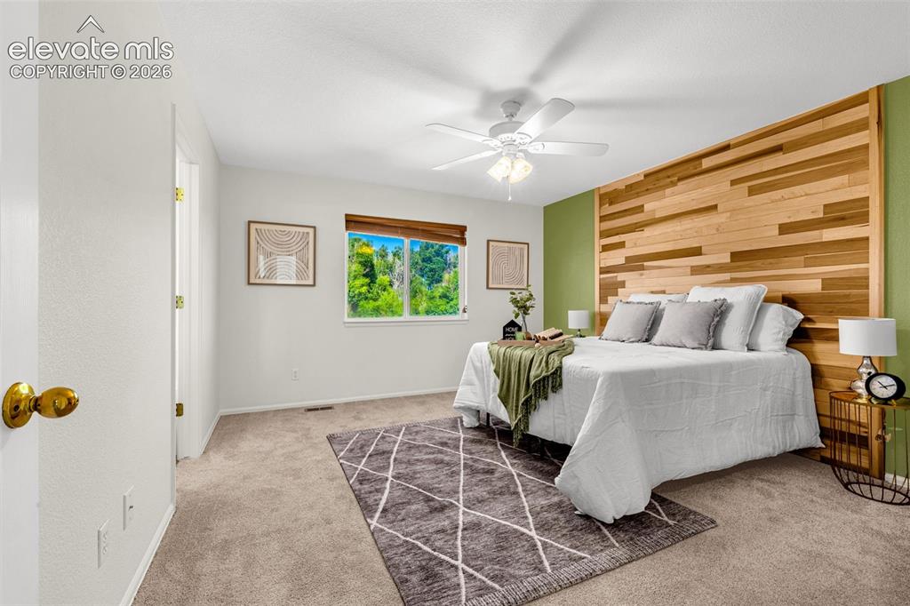 11185 Falling Star Road Fountain, CO 80817 - Photo 10 of 46 a living room with a bed furniture and a window