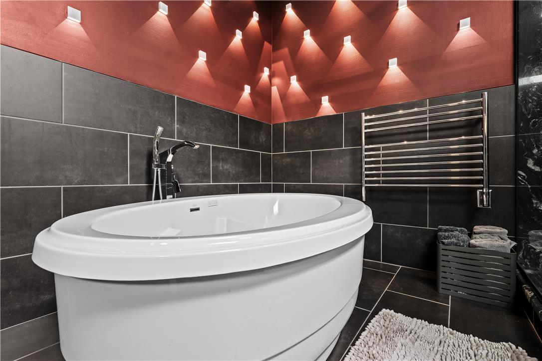 1506 Pleasant View Road Coopersburg, PA 18036 - Photo 48 of 97 Indulge in relaxation with this elegant soaking tub, accented by striking wall-mounted lighting and a heated towel rack.