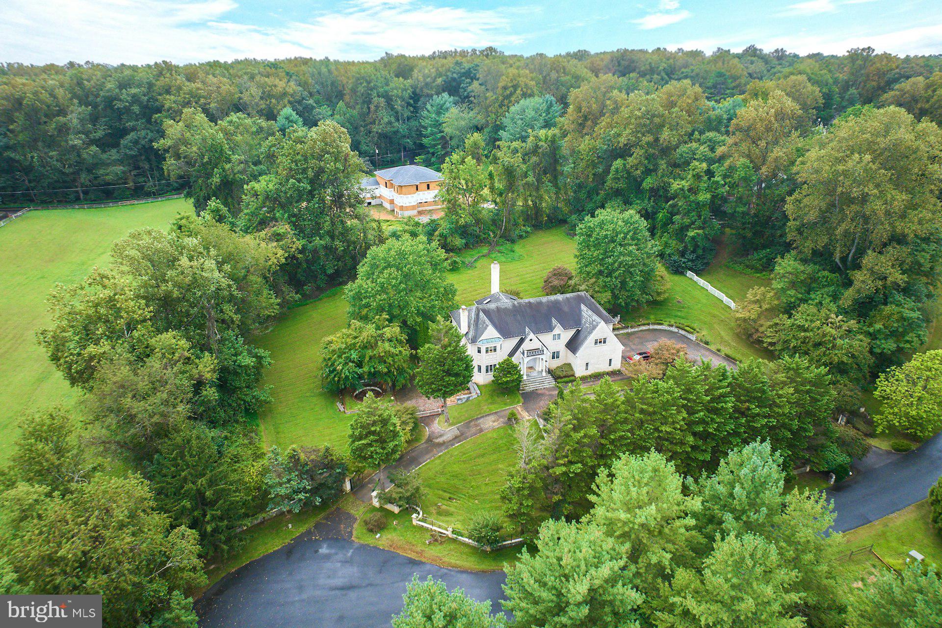 9113 Jeffery Road Great Falls, VA 22066 - Photo 15 of 31 an aerial view of green landscape with trees houses and mountain view