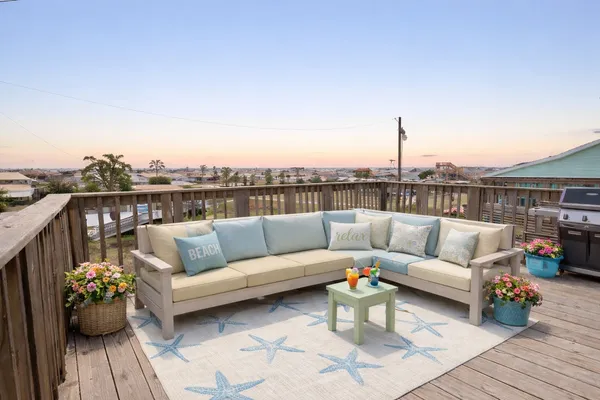 a roof deck with couches and potted plants