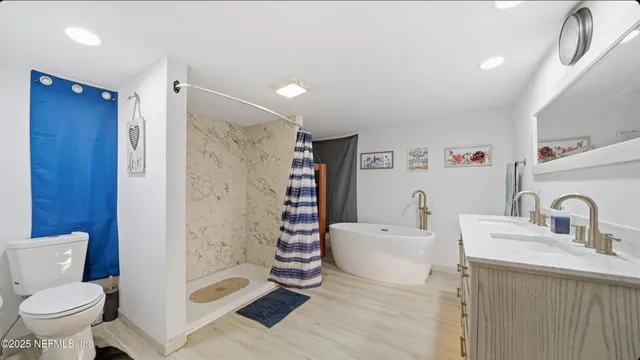 a bathroom with a sink toilet and shower