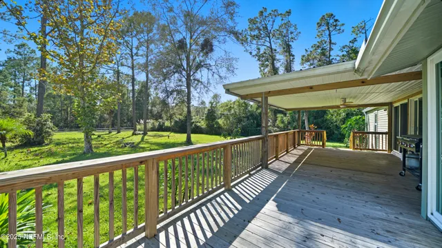 a view of balcony with wooden floor and fence