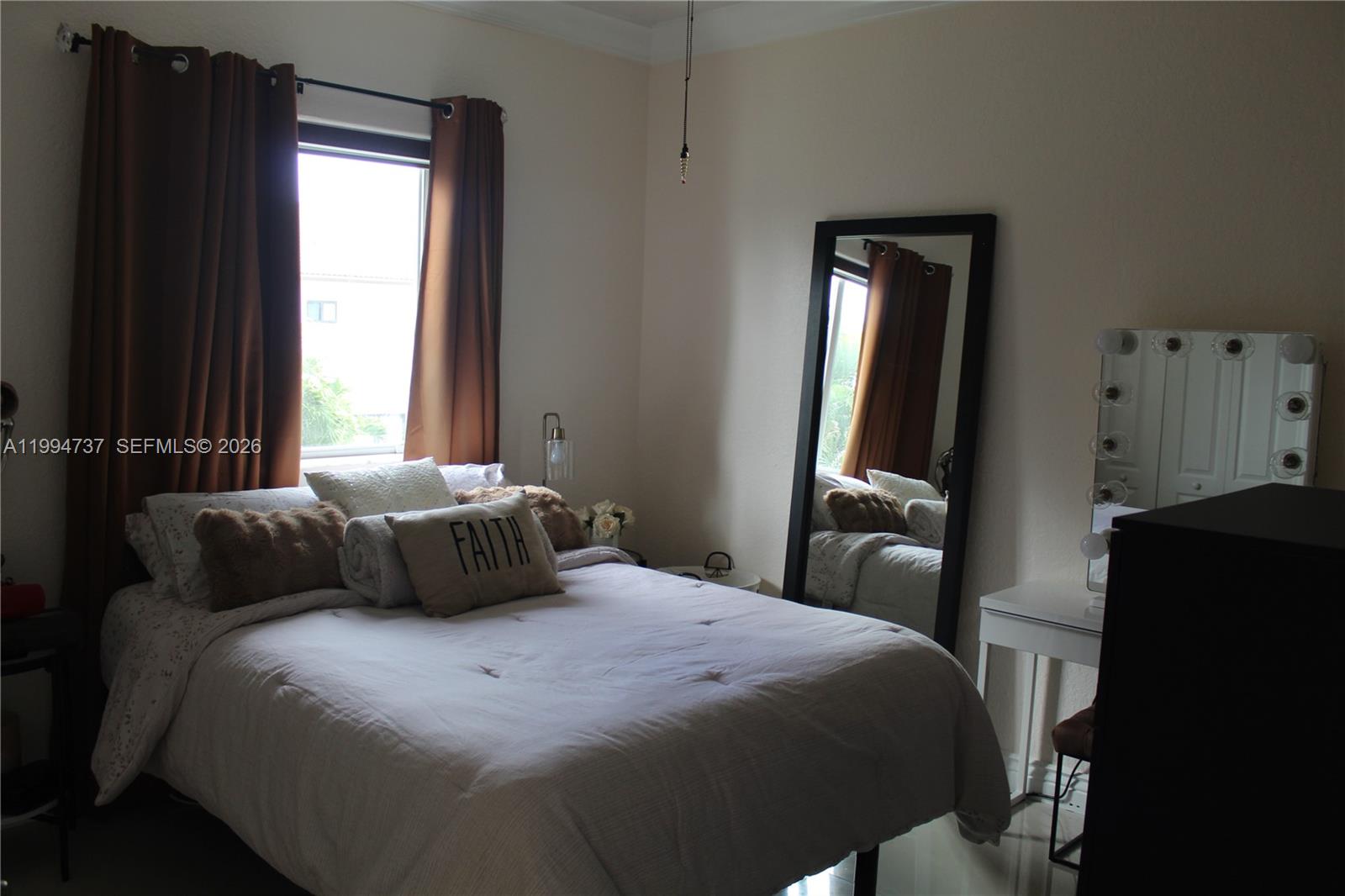 15580 Southwest 176th Terrace Miami, FL 33187 - Photo 20 of 32 a bedroom with a bed and a mirror