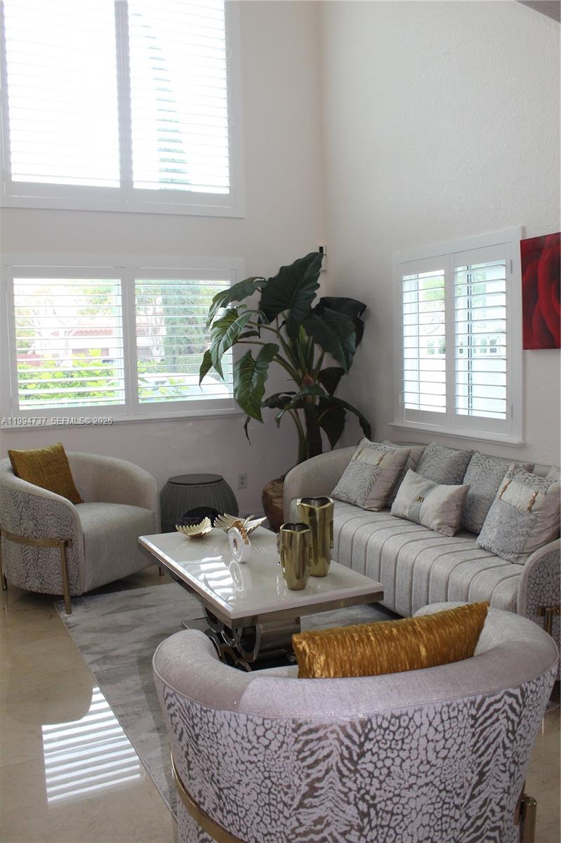 15580 Southwest 176th Terrace Miami, FL 33187 - Photo 2 of 32 a living room with furniture and a window