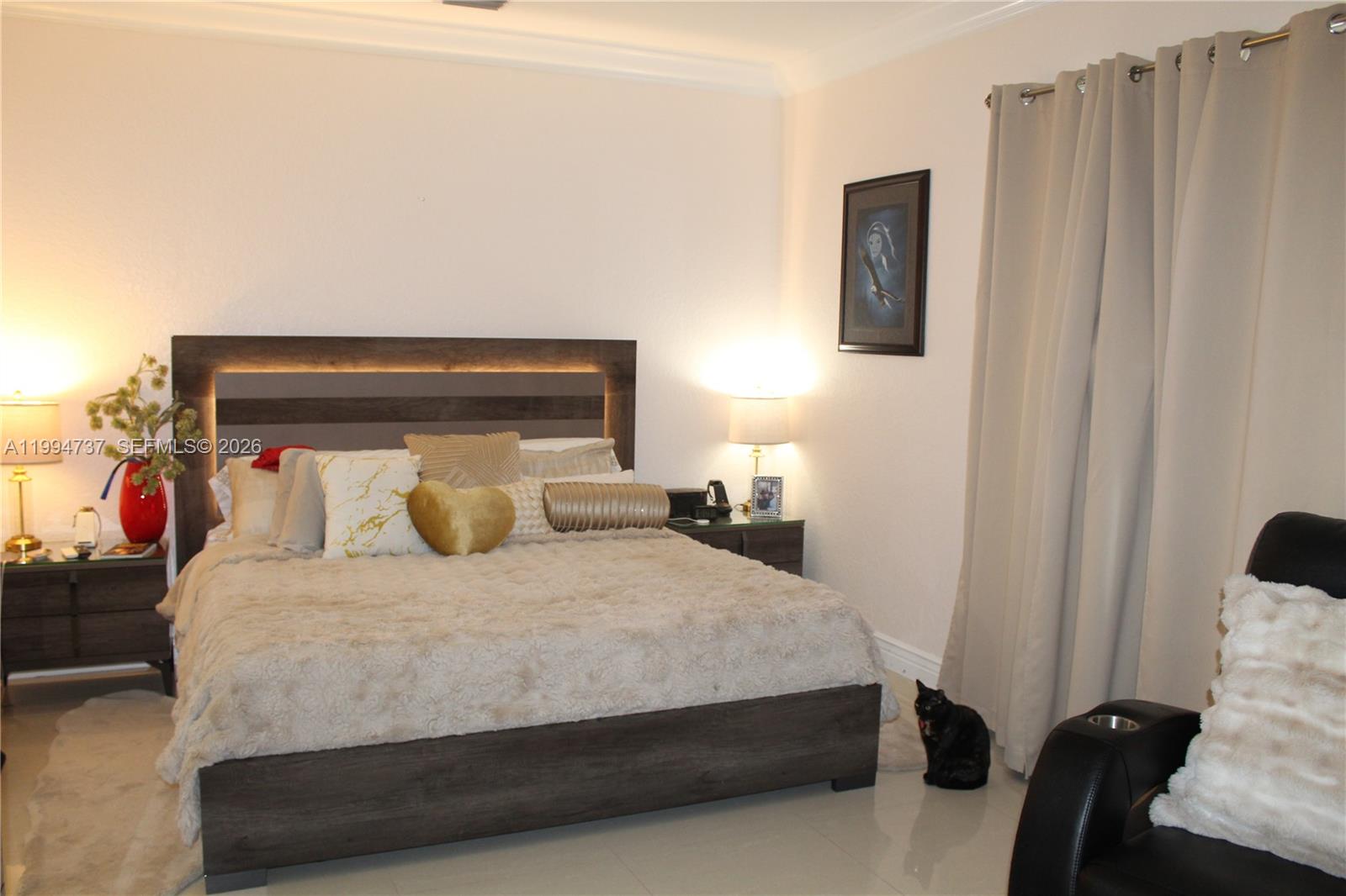 15580 Southwest 176th Terrace Miami, FL 33187 - Photo 23 of 32 a bedroom with a bed and a mirror