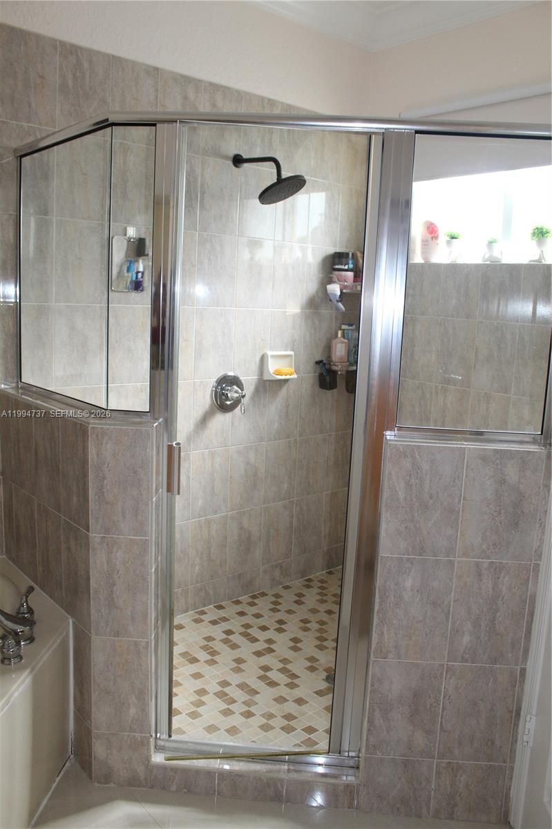 15580 Southwest 176th Terrace Miami, FL 33187 - Photo 26 of 32 a bathroom with a shower and a sink