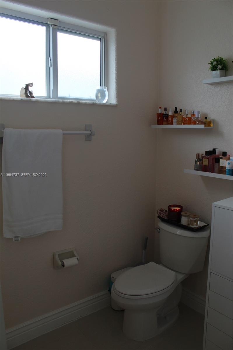 15580 Southwest 176th Terrace Miami, FL 33187 - Photo 27 of 32 a white toilet sitting next to a window