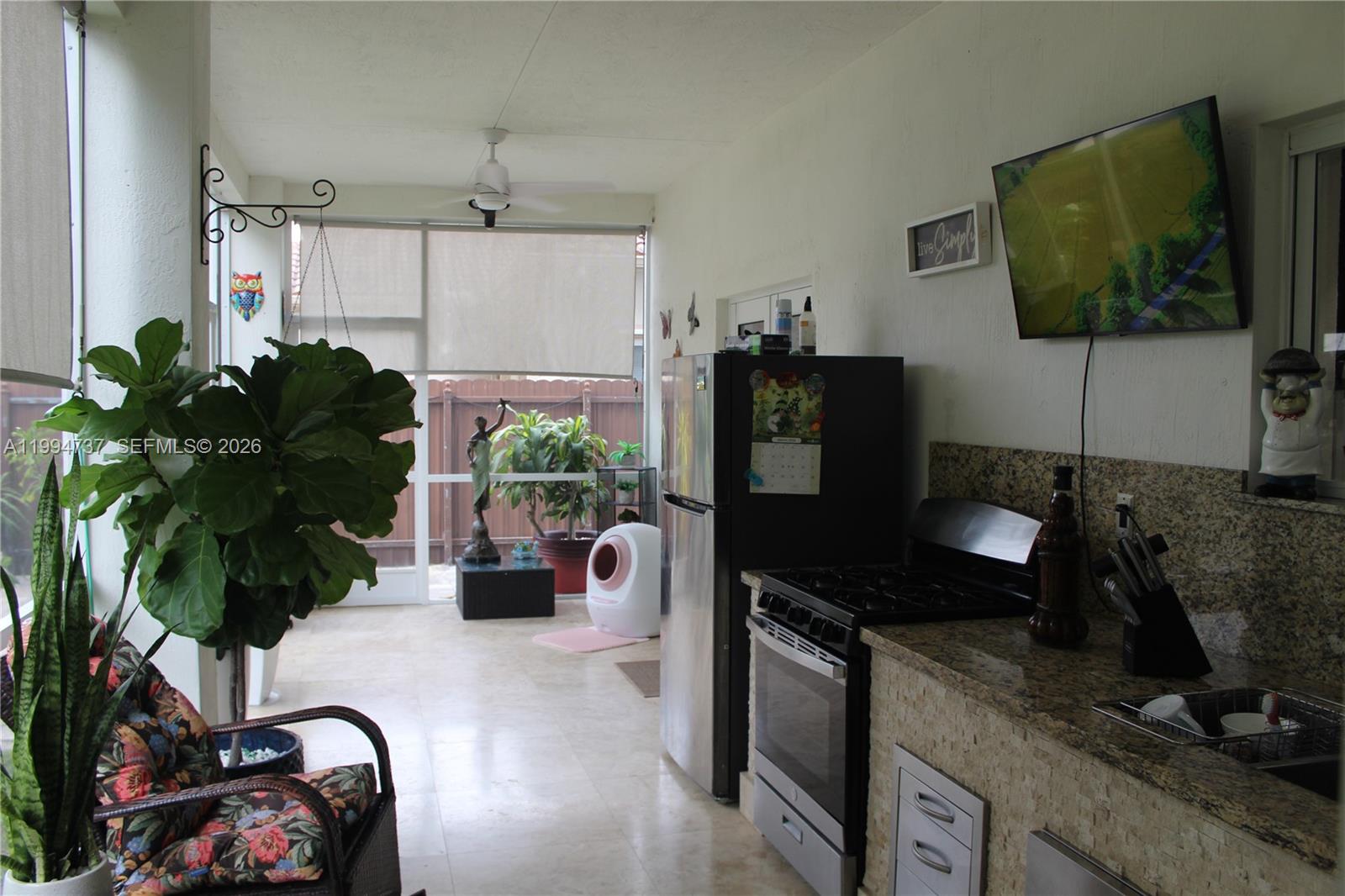 15580 Southwest 176th Terrace Miami, FL 33187 - Photo 28 of 32 a dining room with furniture and a flat screen tv