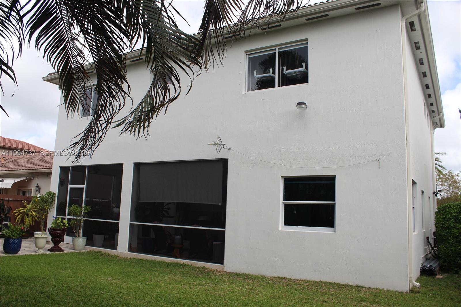 15580 Southwest 176th Terrace Miami, FL 33187 - Photo 31 of 32 a front view of house with yard