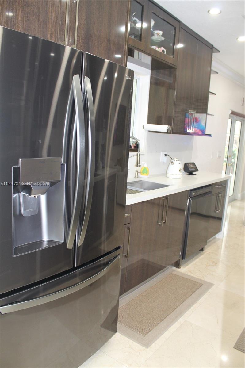 15580 Southwest 176th Terrace Miami, FL 33187 - Photo 7 of 32 a bathroom with a sink a mirror and a shower