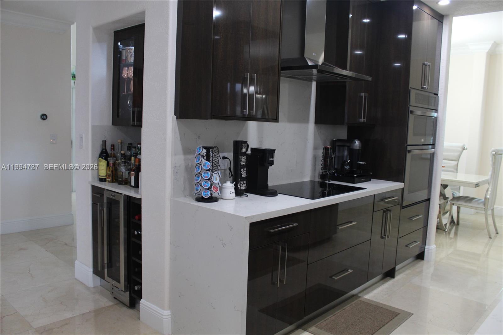 15580 Southwest 176th Terrace Miami, FL 33187 - Photo 9 of 32 a kitchen with stainless steel appliances granite countertop a refrigerator and a sink