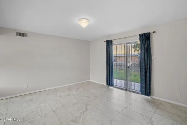 a view of an empty room with glass door