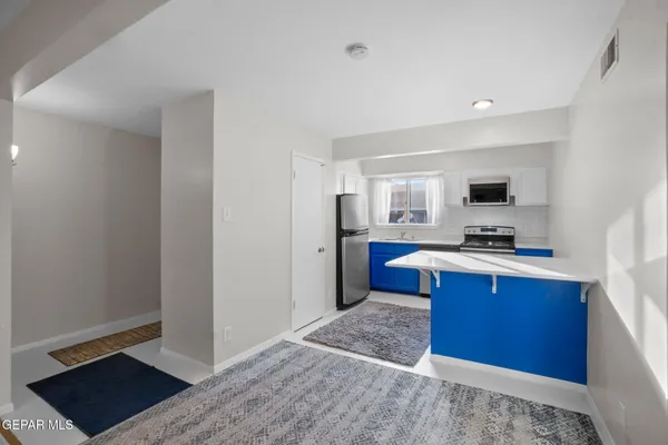 a kitchen with stainless steel appliances granite countertop a stove a sink and a refrigerator
