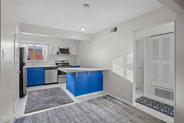 a kitchen with stainless steel appliances granite countertop a refrigerator and stove