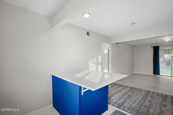 a kitchen with kitchen island a sink and wooden floor