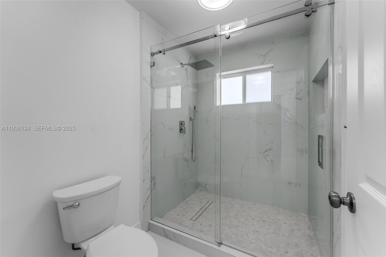 15042 Southwest 149th Court, Unit 1 Miami, FL 33196 - Photo 21 of 46 a bathroom with a shower and toilet