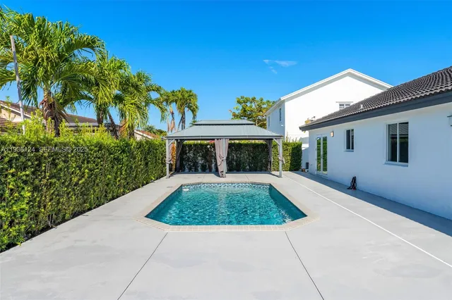 a view of a swimming pool with a yard