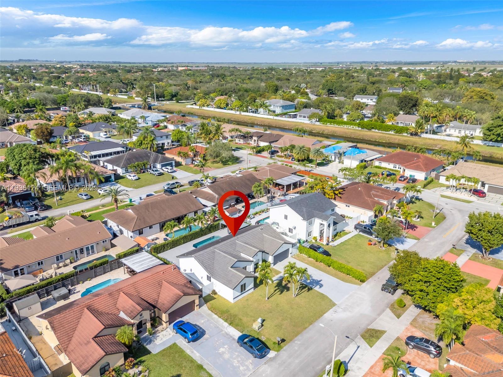 15042 Southwest 149th Court, Unit 1 Miami, FL 33196 - Photo 41 of 46 an aerial view of residential houses with outdoor space