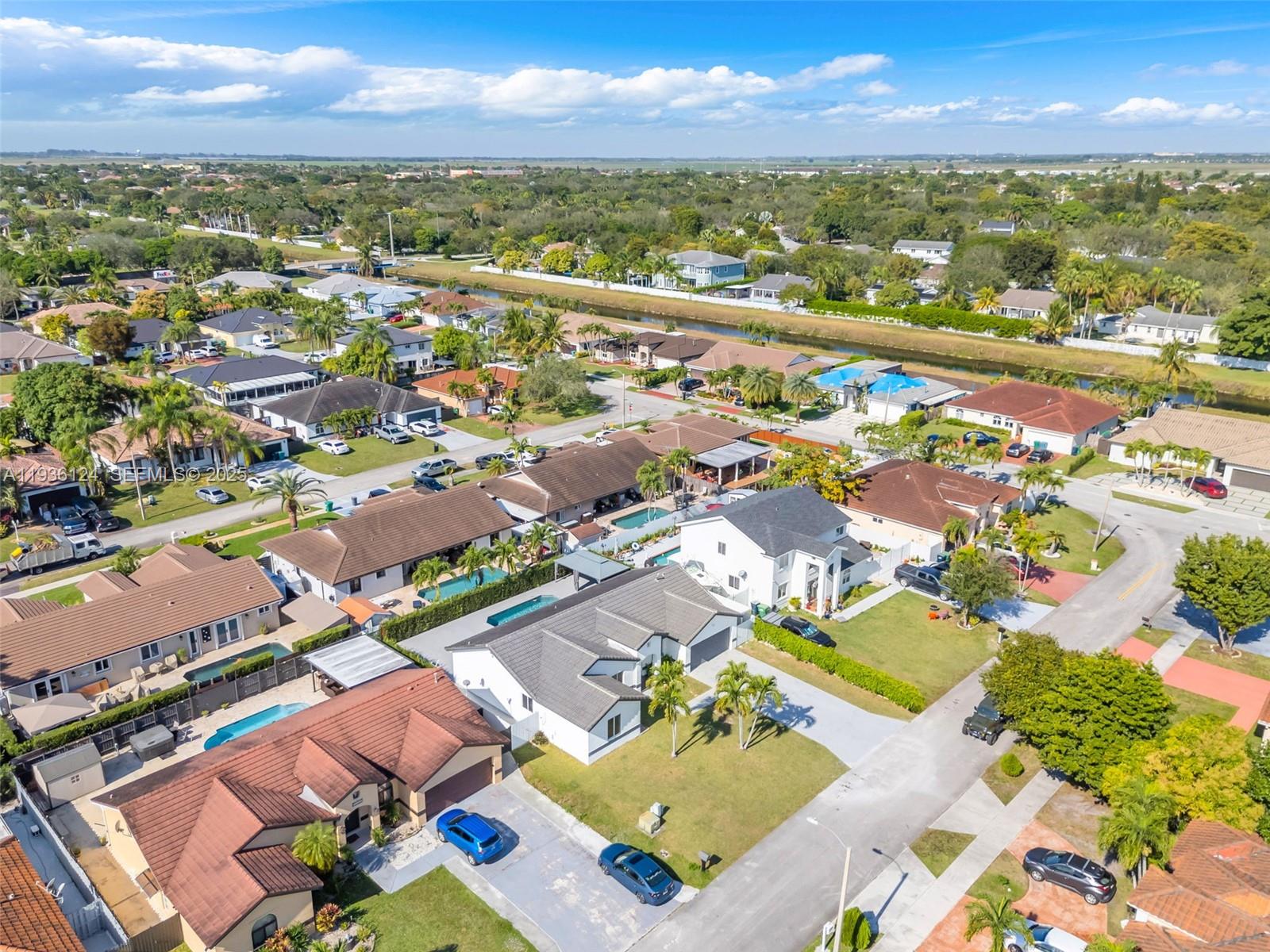 15042 Southwest 149th Court, Unit 1 Miami, FL 33196 - Photo 42 of 46 an aerial view of residential houses with outdoor space