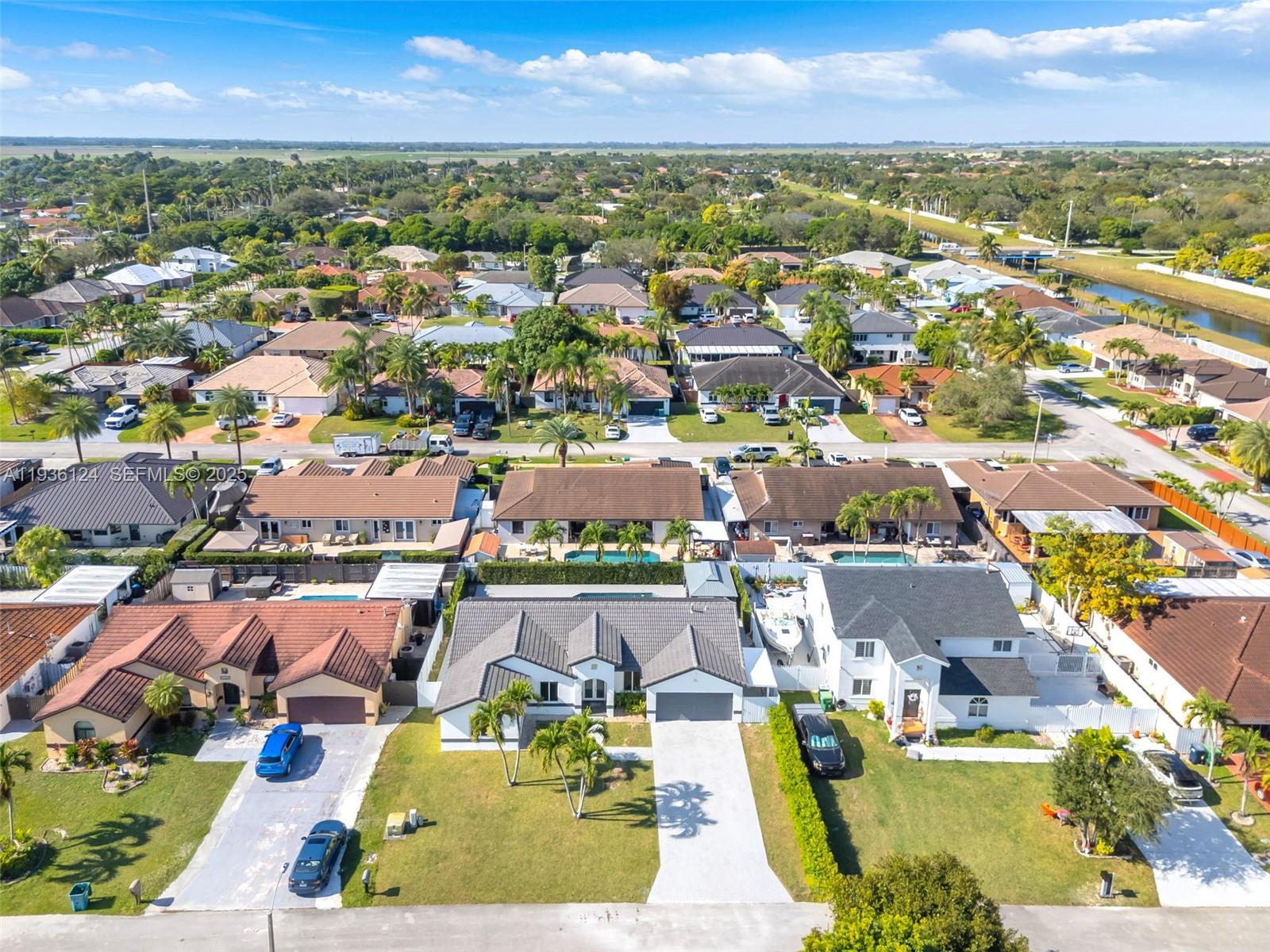 15042 Southwest 149th Court, Unit 1 Miami, FL 33196 - Photo 44 of 46 an aerial view of residential houses with outdoor space