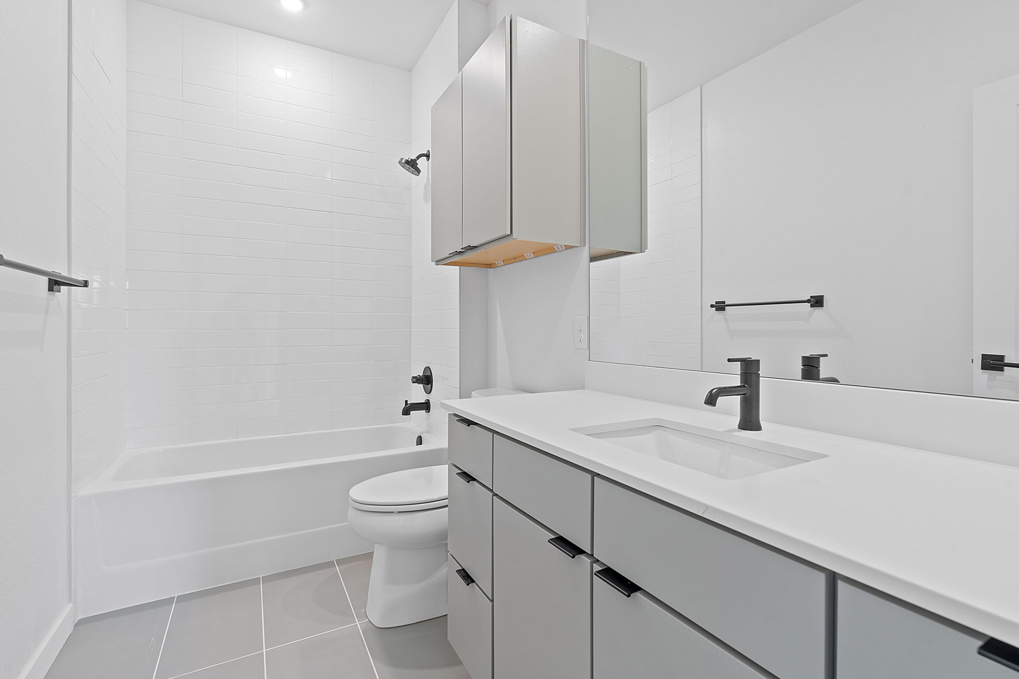 100 West Mockingbird Lane, Unit 307 Austin, TX 78745 - Photo 11 of 23 Bathroom featuring vanity, tile patterned floors, and tub / shower combination