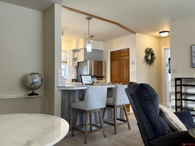a view of kitchen with kitchen island a dining table and chairs