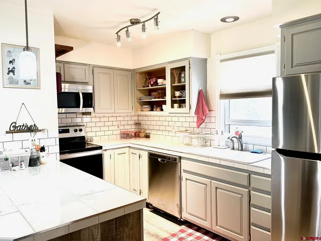 a kitchen with a sink a stove and refrigerator