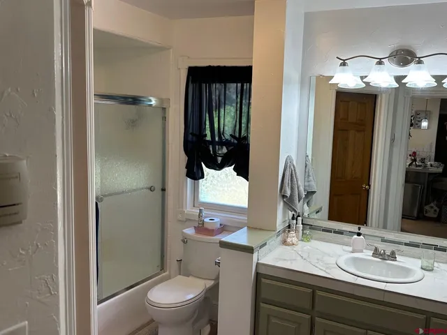 a bathroom with a sink toilet and shower