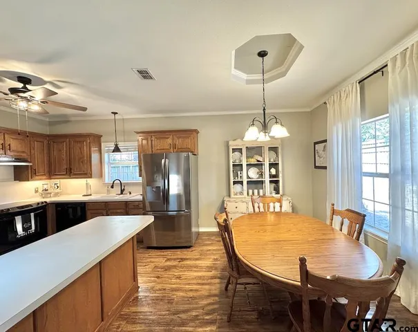 a large kitchen with a table and chairs